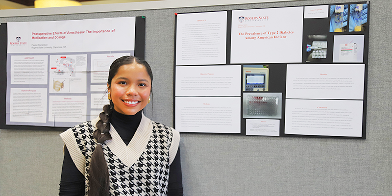 girl standing by poster presentation