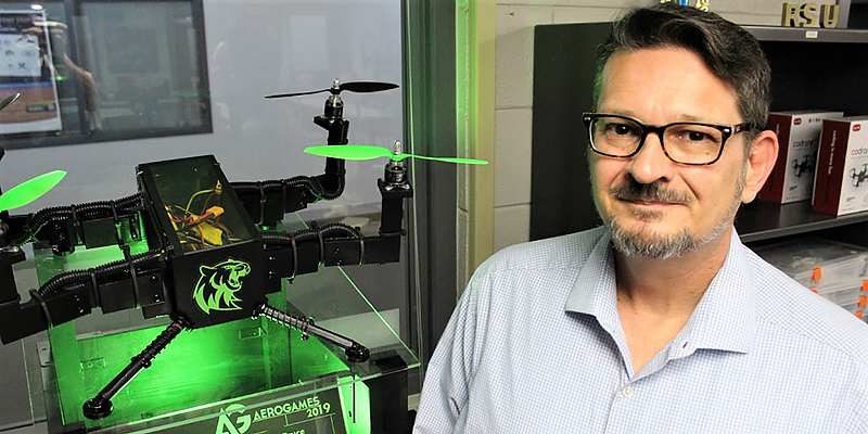 Curtis Sparling standing next to drone
