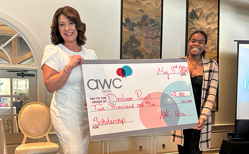 two women holding large check