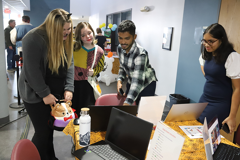 group at tech booth for halloween